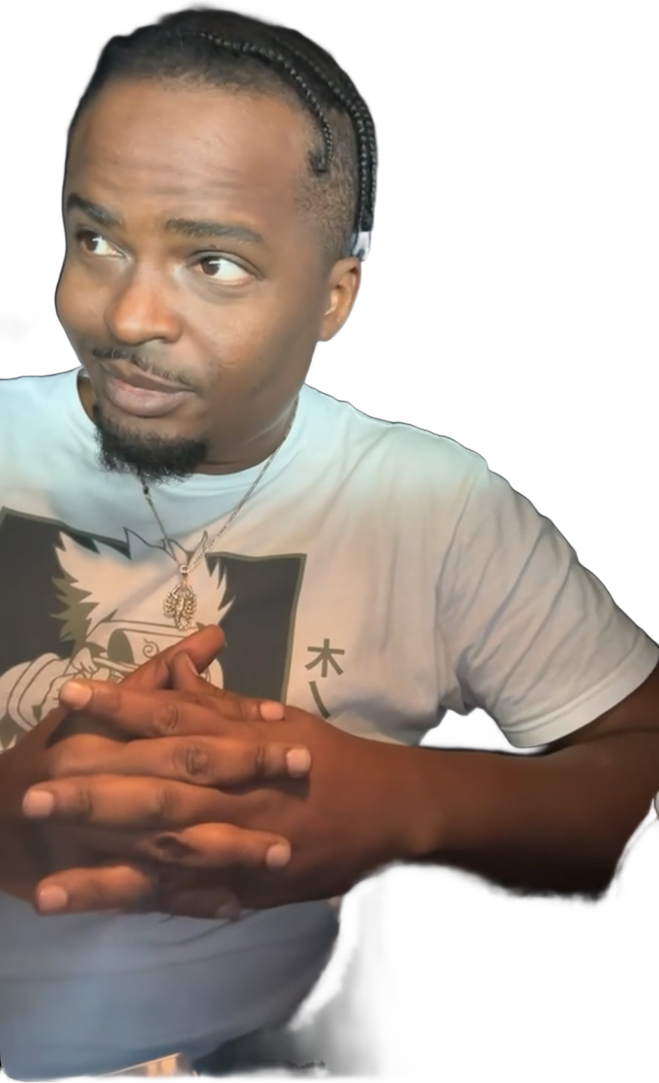 Christopher Charles with braided hair in a graphic T-shirt, hands clasped
